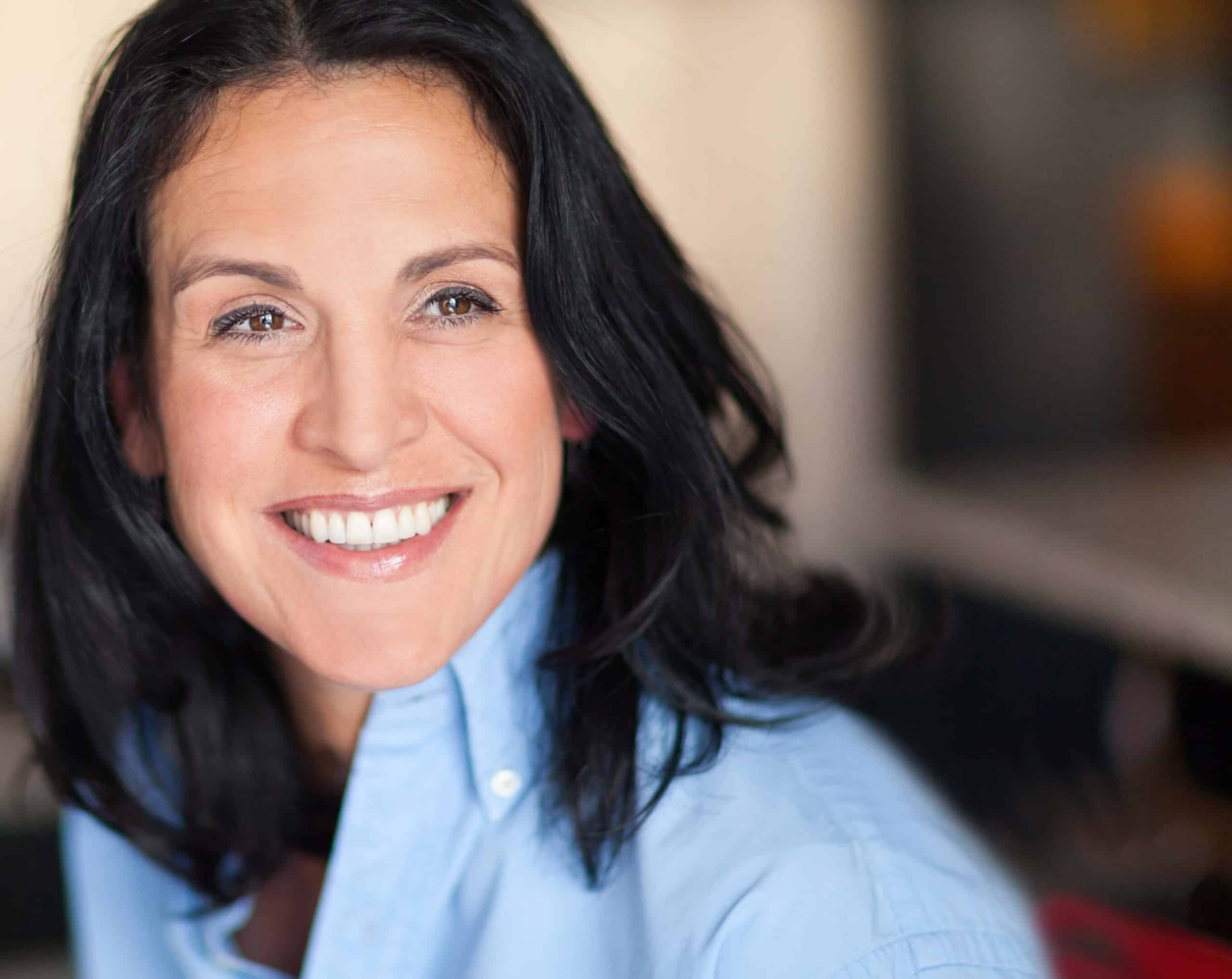 Mature woman wearing a blue collared top